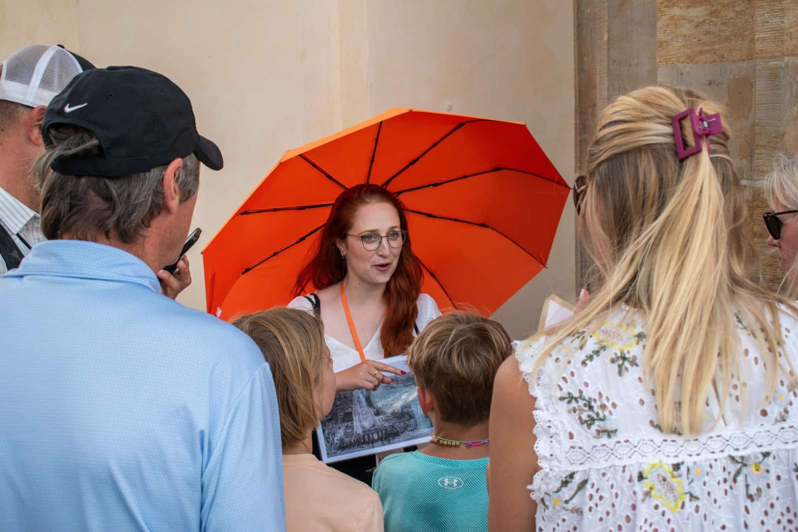 Natalie from Walkabout Tours showing guests a photograph of Berlin on a Private Walking Tour